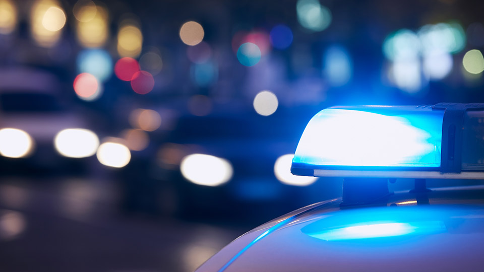 Mutmaßlicher Täter festgenommen: Streifenwagen der Polizei mit Blaulicht in der Nacht.