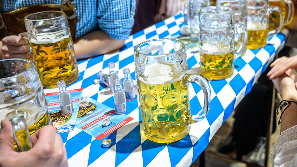 Koblenz Germany 27.09.2019 Close-up of bavarian beer glasses 1 liter bitburger Beer on table decoation at Octoberfest