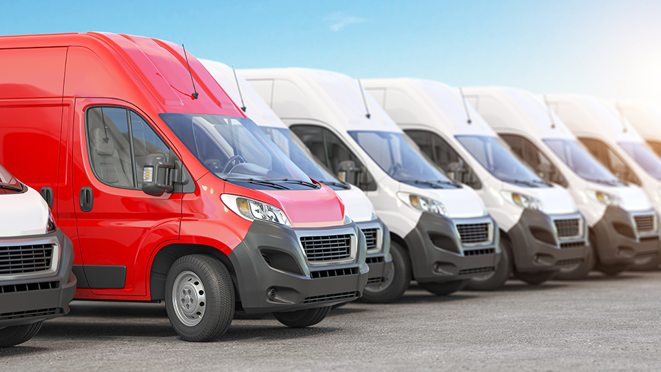 Flottenversicherung: Eine Autoflotte mit weißen und einem roten Auto.