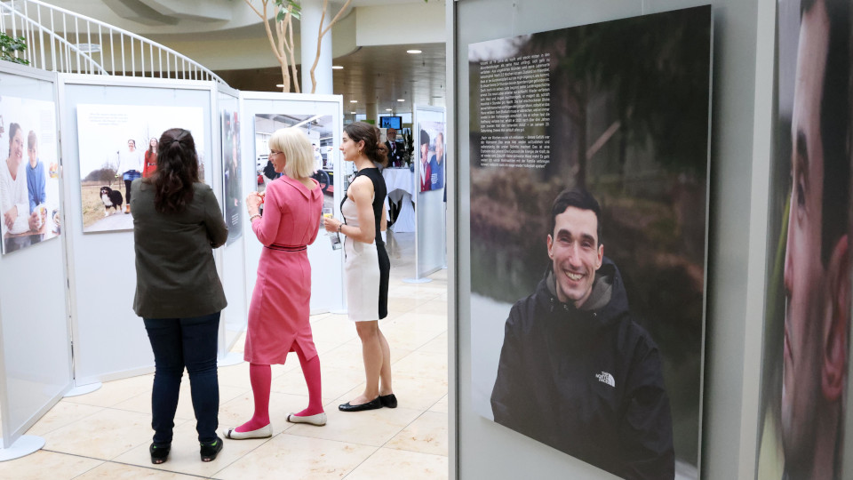 Drei Frauen stehen vor einem Bild der Ausstellung