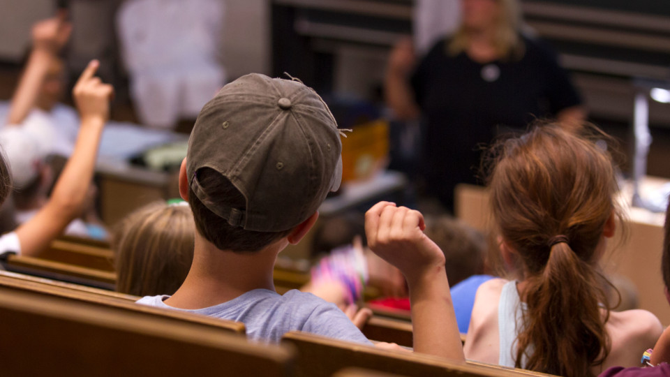 Kinder sitzen im Hörsaal