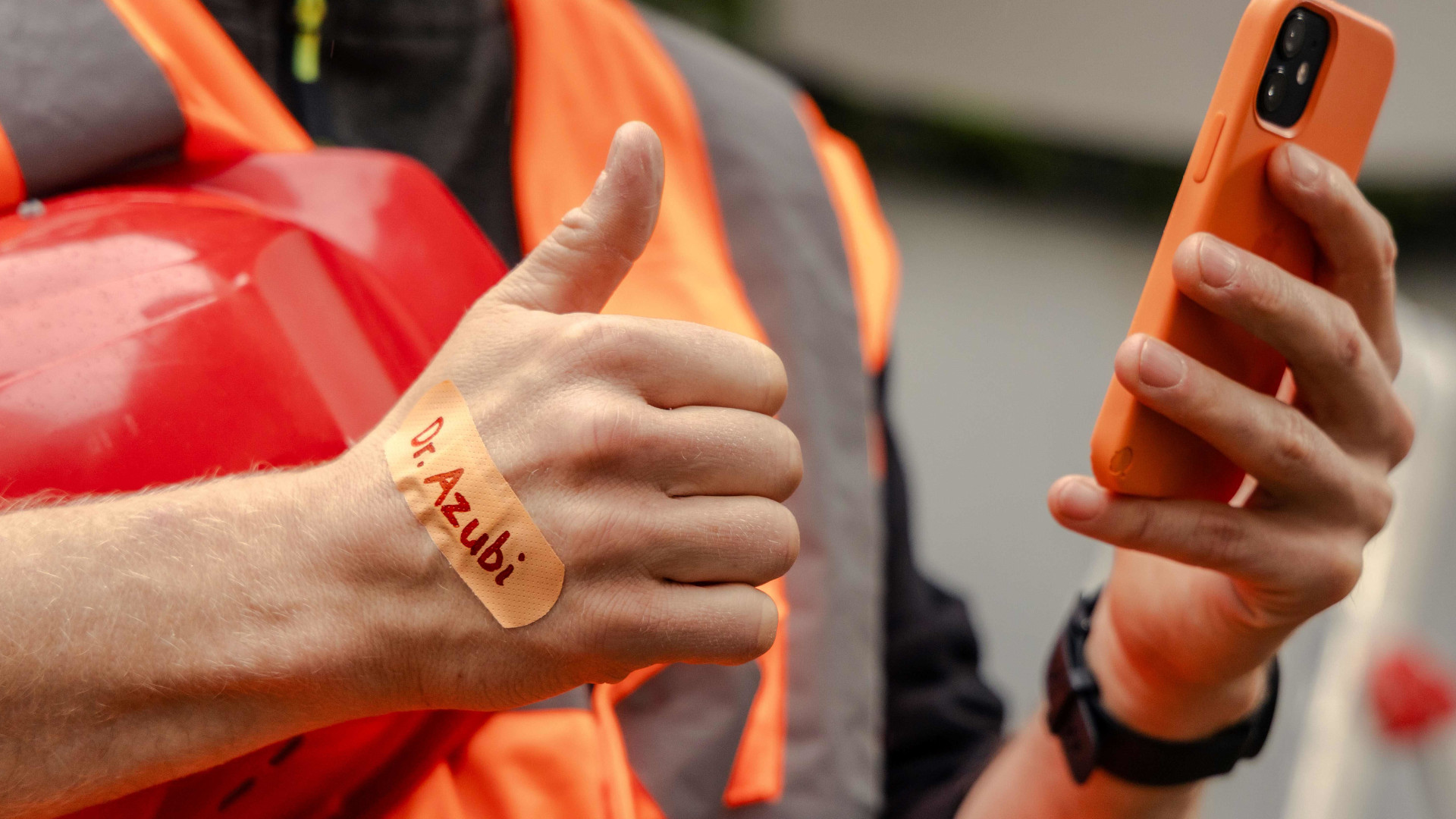 Symbolbild: Azubi hält Handy in der Hand