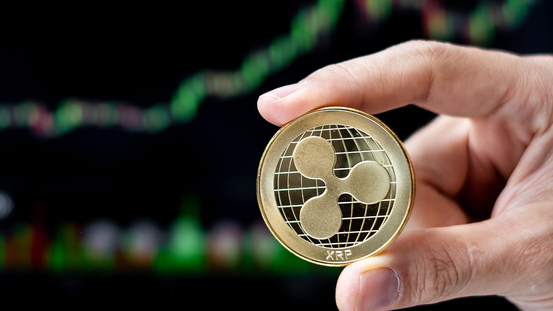 Symbolbild: Hand hält XPR Münze