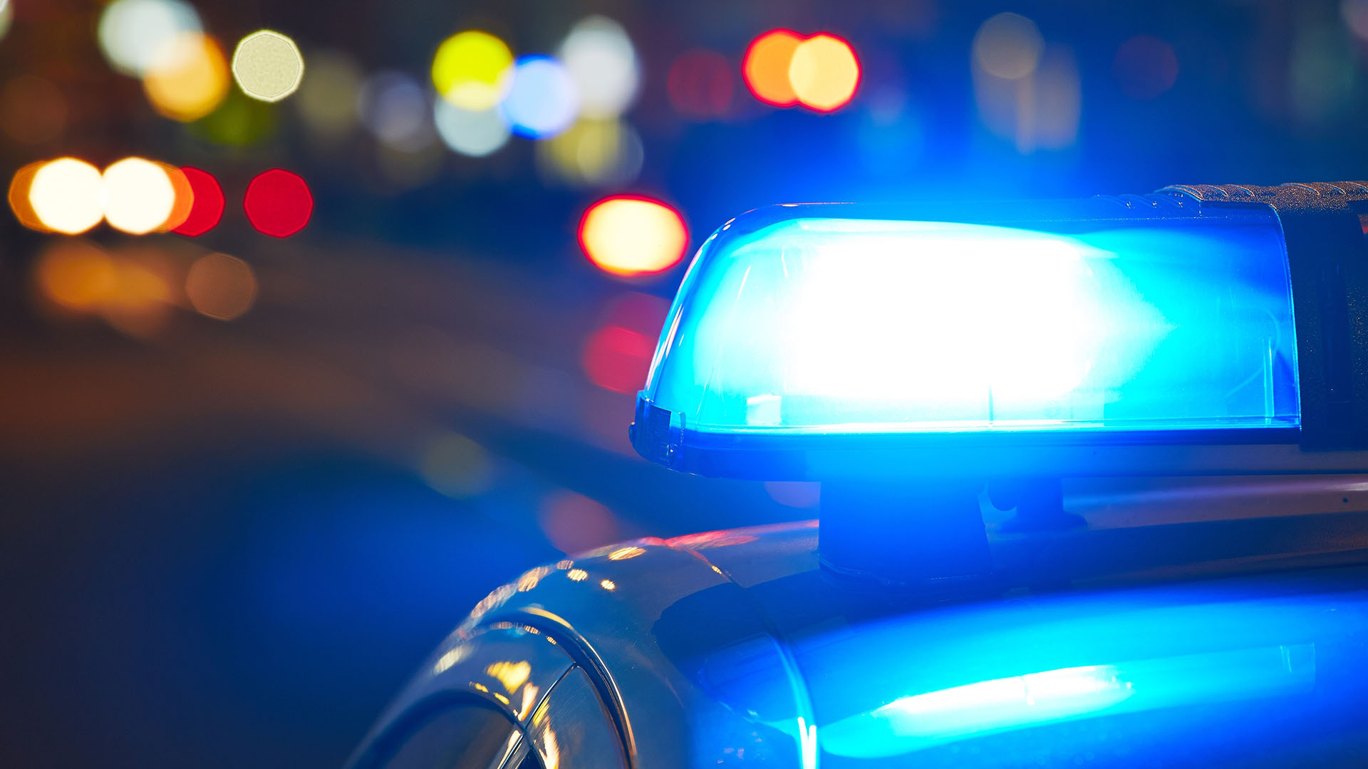 Streifenwagen der Polizei mit Blaulicht in der Nacht